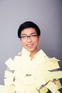 Smiling asian man pasted stickers