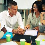 Business people having meeting around table in office