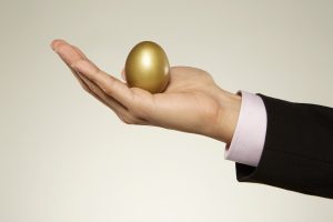 hand holding a golden egg= nonprofit income strategy
