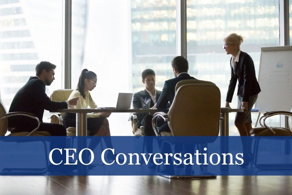 group of people meeting at a table talking