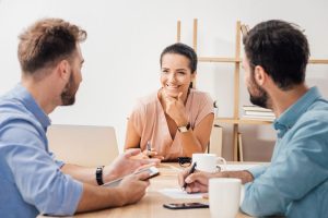 three people at meeting smiling