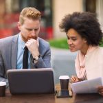 man and woman looking at a laptop