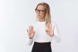 Woman with hands up pushing back