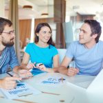 Group of three people in working at a meeting in an office