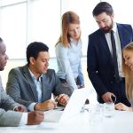 Group of people having a discussion at a table.