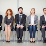 employees sitting on chairs waiting