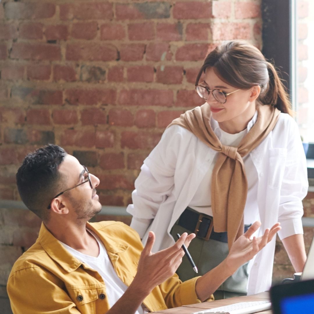 Supporting Resources a man and woman talking in a work setting