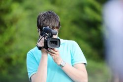 Cameraman filming a volunteer and donor