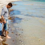 Man with child at the beach-decorative