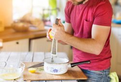 a man cooking in a sauce pan