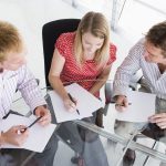 a group of people working at a meeting