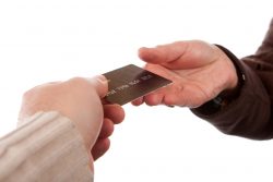 two hands passing a credit card